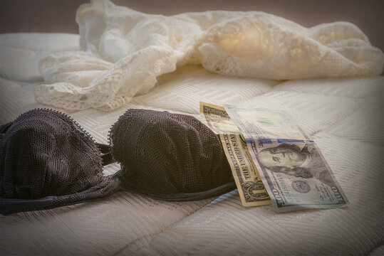 Bra of prostitutes on the couch with her money.