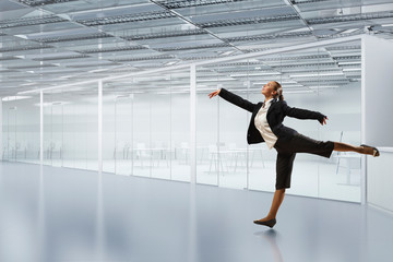 Dancing businesswoman in office . Mixed media