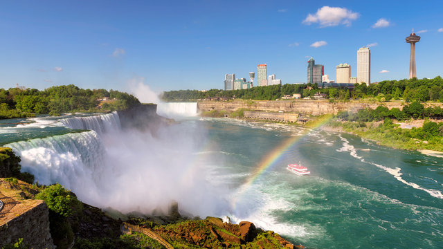 Niagara Falls and rainbow from the American side with the skyline of the city of Niagara Falls