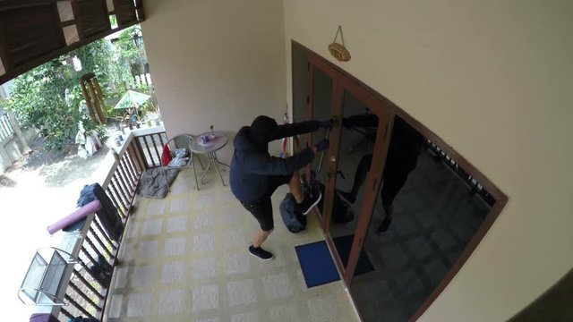 Burglar Trying to Break Open A House. 4K
