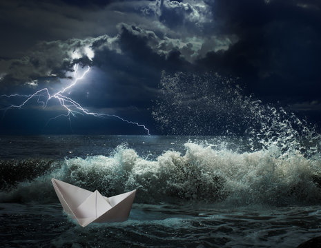 Paper Boat In Ocean Storm With Lgihting And Waves