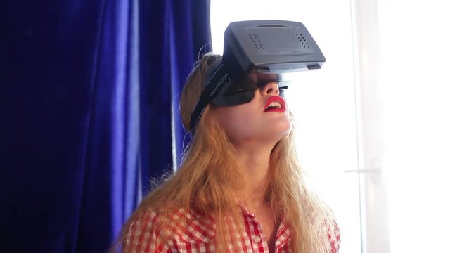 girl testing a virtual reality glasses at home