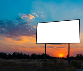 Blank billboard ready for new advertisement with sunset background.
