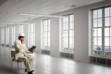 Businessman in white suit in office . Mixed media