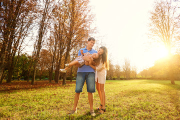 Happy family in the park. Parents with child walk,play in the na