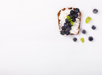 Sweet sandwich with cream-cheese blueberries over a white background . Top view. healthy breakfast.Copy space.selective focus.