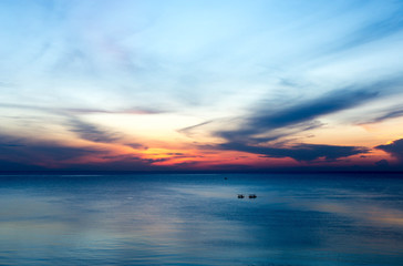 beautiful sunrise with fishing boat in the sea