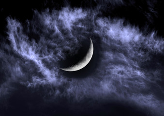 Naklejka na ściany i meble The moon in the night sky in clouds