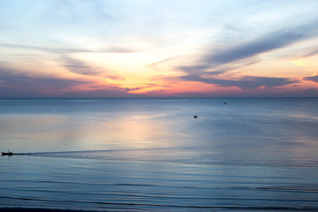 beautiful sunrise with fishing boat in the sea