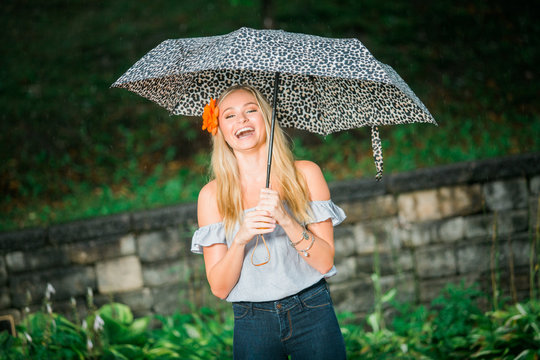 High School Senior Poses With Umbrella For Portraits On A Rainy