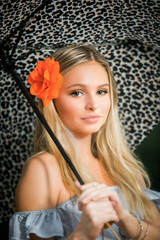 High school senior poses with umbrella for portraits on a rainy