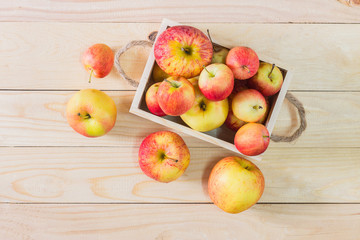Fresh Apples in a wooden crate on wooden table background