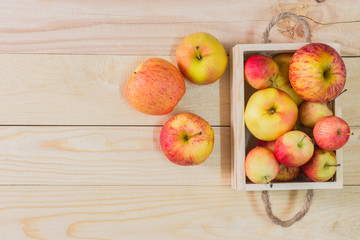 Fresh Apples in a wooden crate on wooden table background