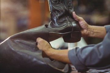 Cobbler making leather boots 