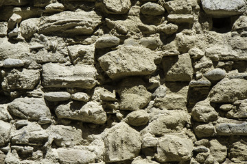detail of the old wall of stones in ruins.