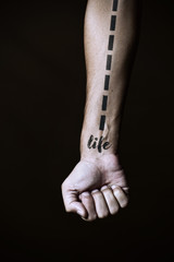 dashed line and word life in a forearm