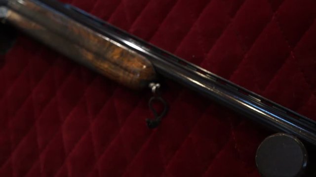 Old beautiful rifle on a red fabric background