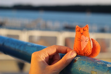 Orange fox on palm. Textile handmade fabric doll toy.