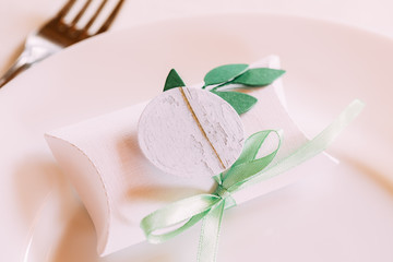Wedding Candy-box Lies On A Plate. Bomboniere Is Part Of Decorat