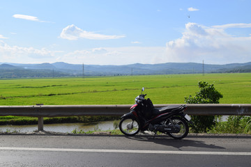 Fototapeta na wymiar rice paddy field and motorbike
