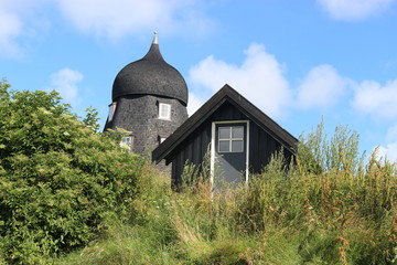 Obraz premium Black wooden houses in the dunes. In the town Lonstrup, on the west coast of Denmark, North Jutland, Europe.