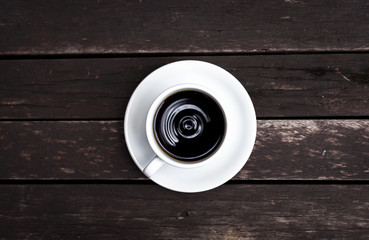 Black coffee on vintage wooden background
