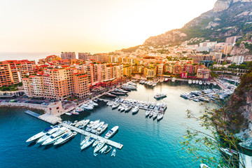 Panoramic view of Port de Fontvieille in Monaco. Azur coast. Colorful bay with a lot of luxury yachts in sunset. - obrazy, fototapety, plakaty