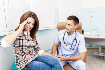 at a reception at the doctor Female patient holding his head. Visit a doctor in the hospital sick woman. Migraine