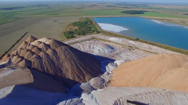 4k areal shows how work above potash mines organized. Huge artificial mountains tailings piles near Soligorsk city Belarus are formed by waste left after potash salt extraction from underground mines