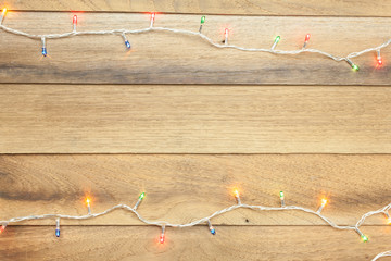 Light christmas top view with wooden background