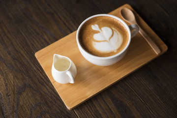 Hot latte art on wood table