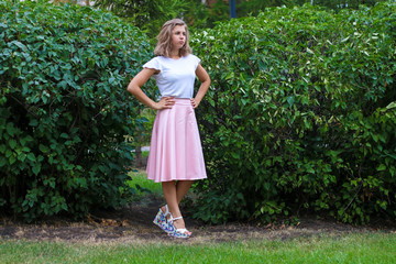 Young woman posing near the bushes