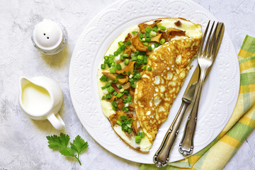 Omelet stuffed with chanterelle mushrooms and cheese.Top view.