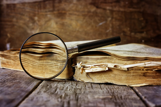 Magnifying Glass And Old Book