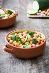 Chickpea salad on in bowl wooden background

