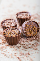 Four sweet cupcakes made from nuts and chocolate