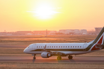 Fototapeta na wymiar airplane on a starting runway evening sundown