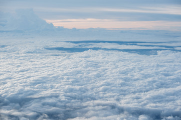 Clouds and sky as seen through window of an aircraft