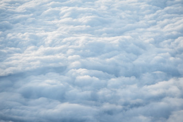 Clouds and sky as seen through window of an aircraft