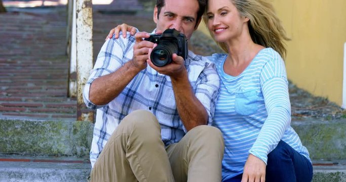 Couple looking at photographs in digital camera