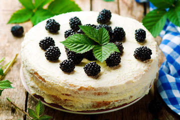 Honey cake with blackberry and whipped cream.