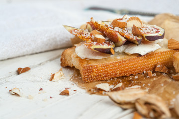 Bruschetta with goat cheese and figs on list of parchment