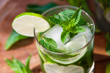 Mojito mint cocktail decorated with lime on wood