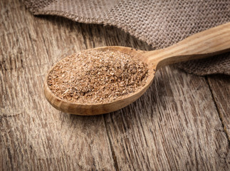 Wheat bran in wooden spoon