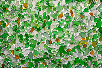 Color pieces of glass, polished water and sand.