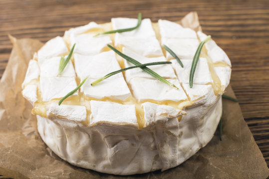 Camembert with rosemary on a wooden board