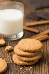 Biscuits with glass of milk on natural wooden table..