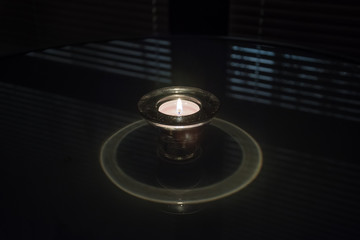 Radiant tea candlestick with a candle.