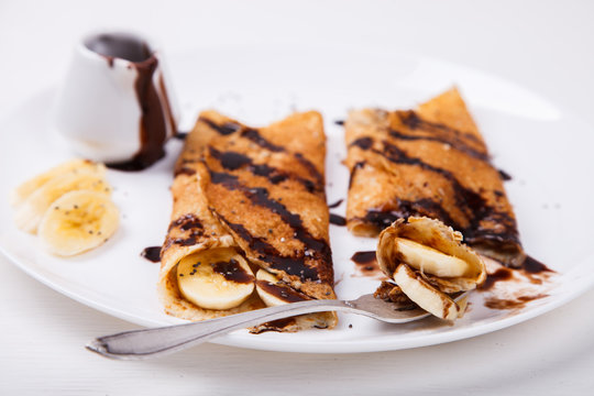 Pancakes with banana and chocolate topping.selective focus.