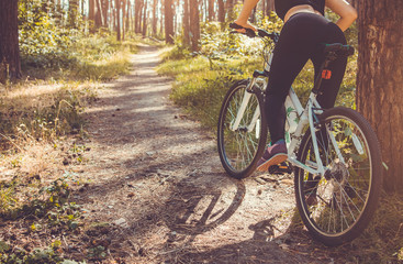 Fototapeta premium Woman riding a bicycle in the forest